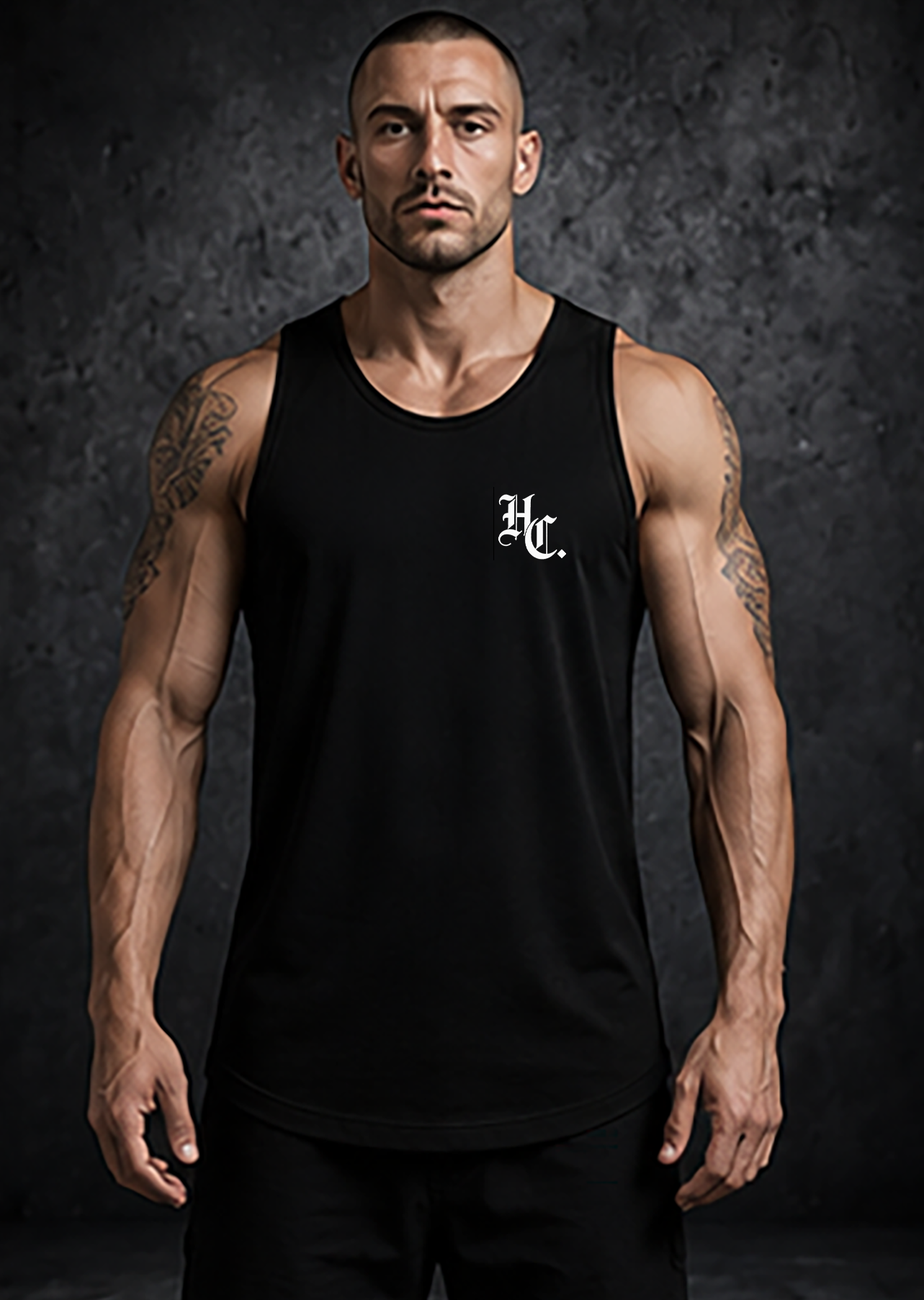 Man wearing a black tank top with a logo on a dark background