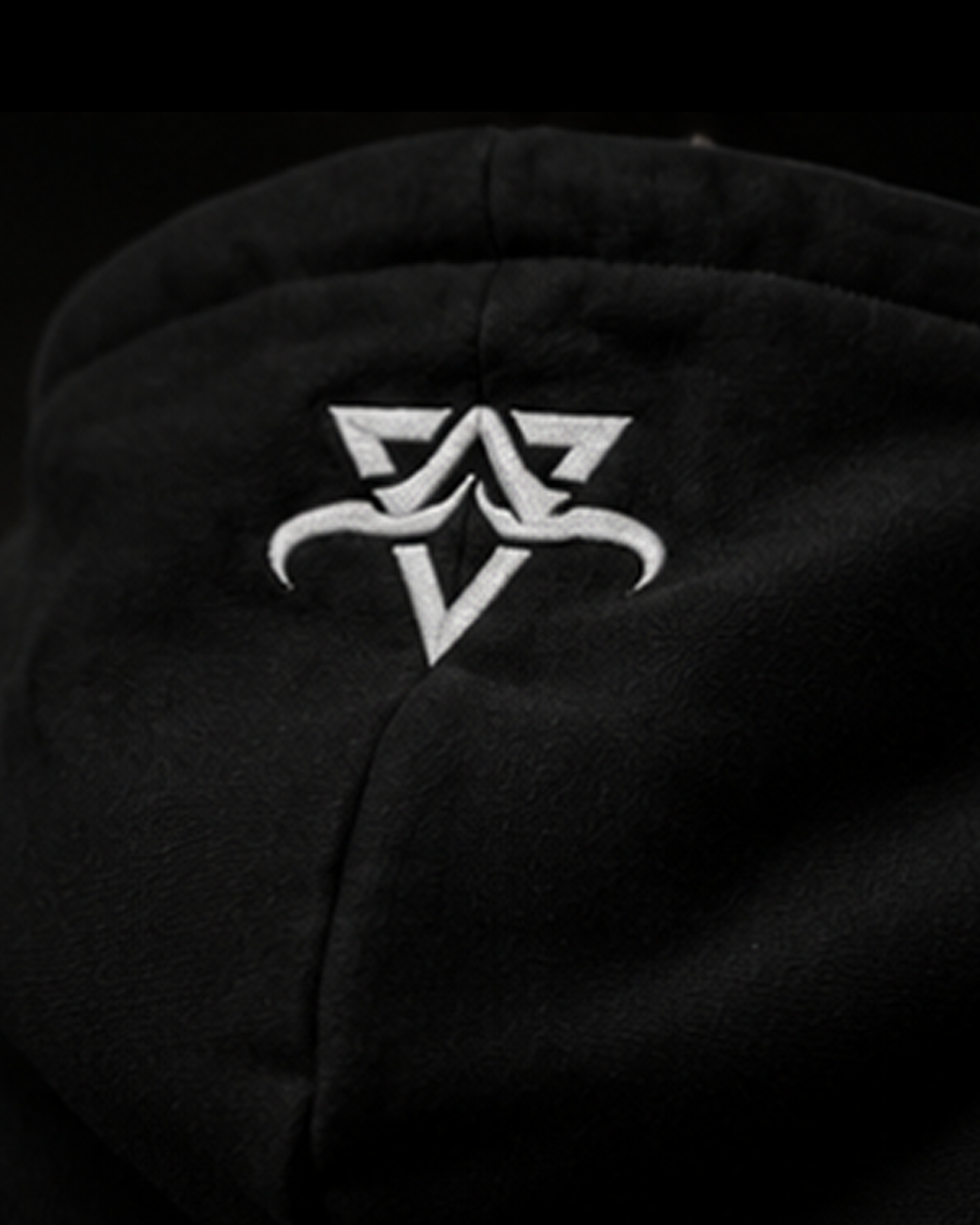 Black hoodie with a white logo on a dark background