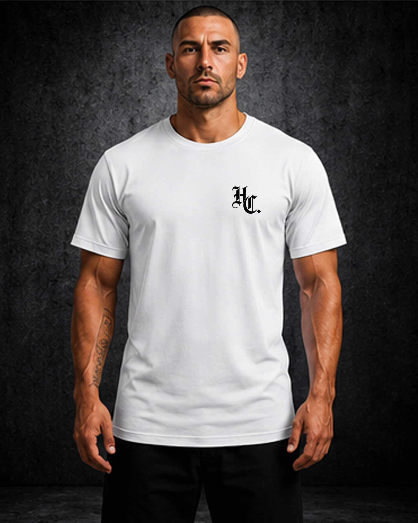 Man wearing a white t-shirt with a logo on a dark background