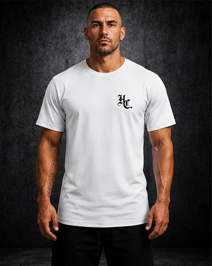 Man wearing a white t-shirt with a logo on a dark background