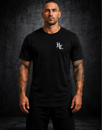 Person wearing a white t-shirt with 'Hardline Co.' branding on the back against a dark background