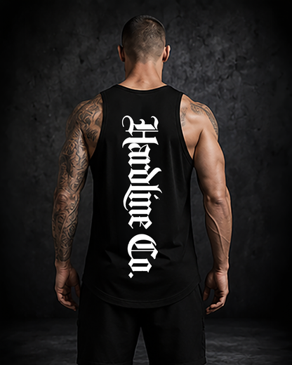 Person wearing a black tank top with white text on the back against a dark background