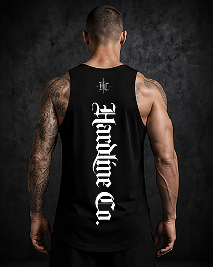 Person wearing a black tank top with white text on a dark background