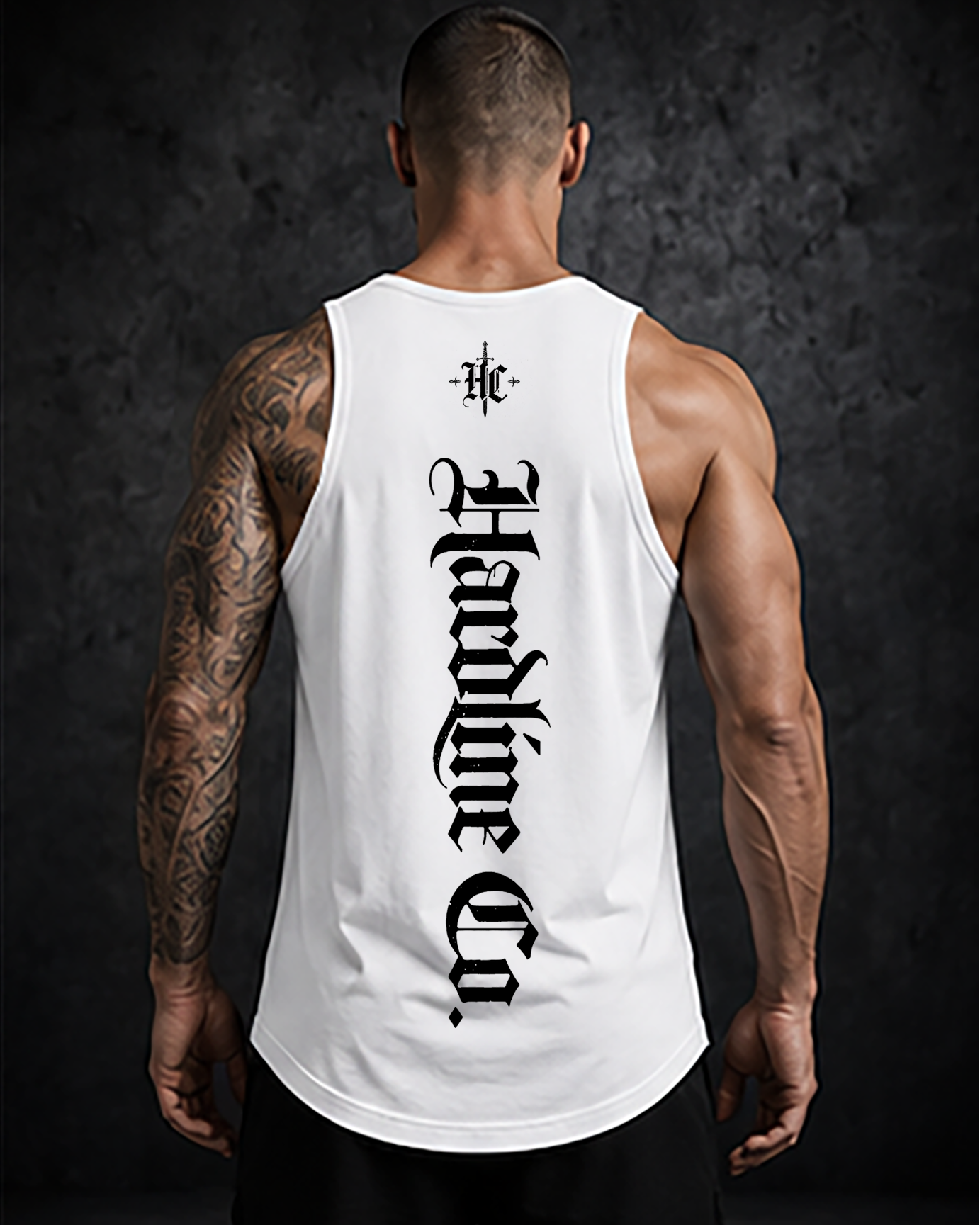 Person wearing a white tank top with black text and logo on the back against a dark background