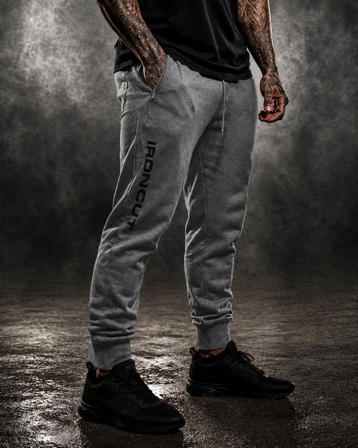 Side view of grey DBXA Ironcut Fleece Pants showing the leg wordmark