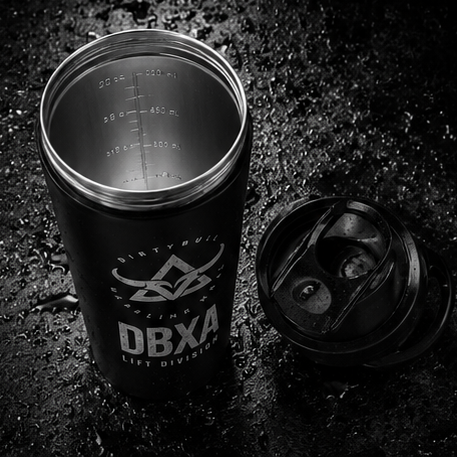 Black tumbler with DBXA logo on a dark textured surface