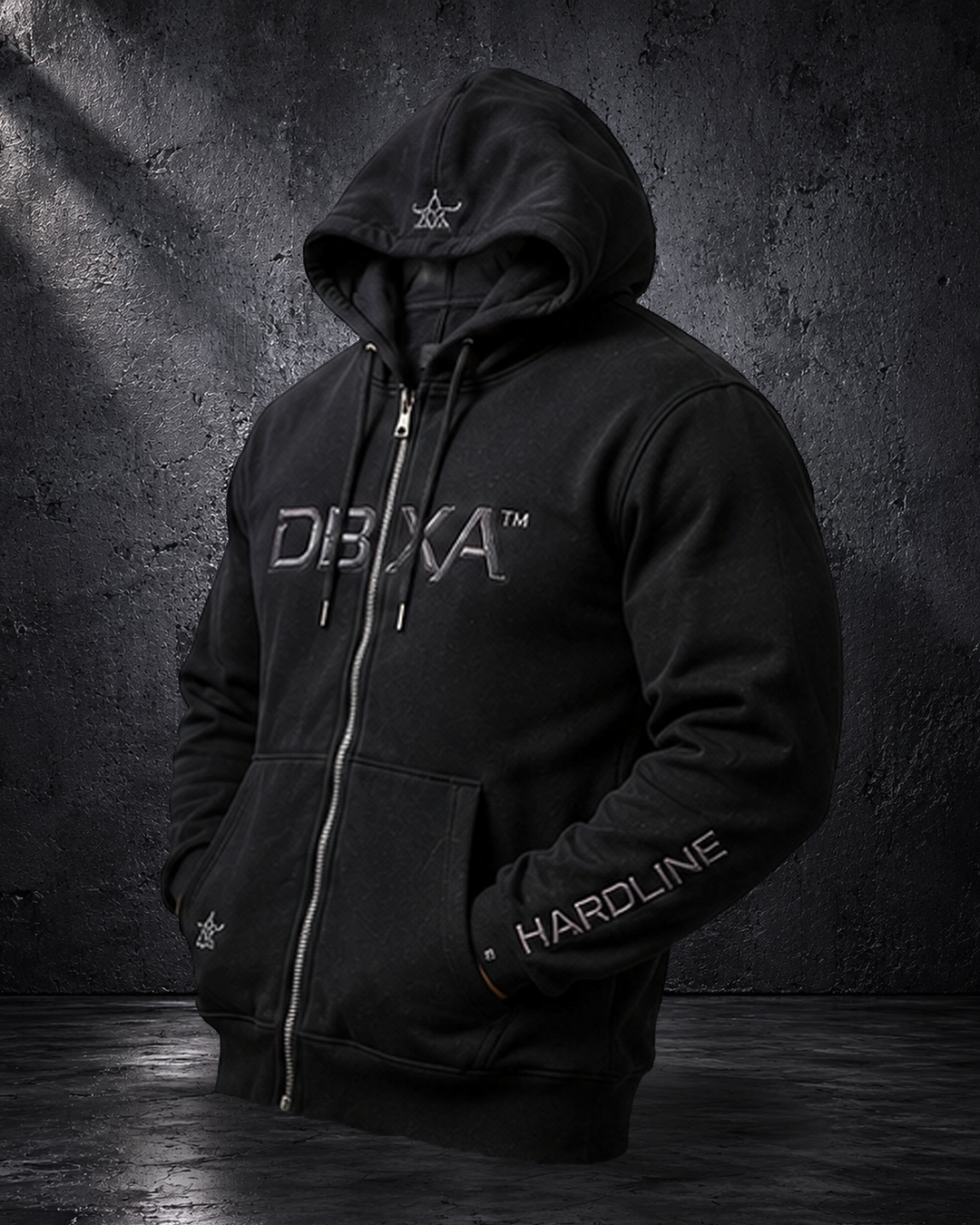 Black DBXA Ironveil zip hoodie front with metallic DBXA chest embroidery and HARDLINE sleeve branding.