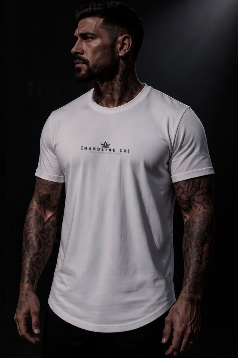 A muscular man with tattoos wearing a white crewneck t-shirt with a black HARDLINE CO..&