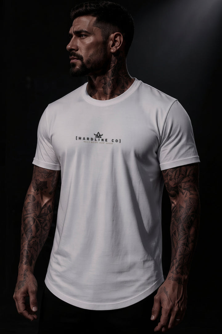 A muscular man with tattoos wearing a white crewneck t-shirt with a black HARDLINE CO..&