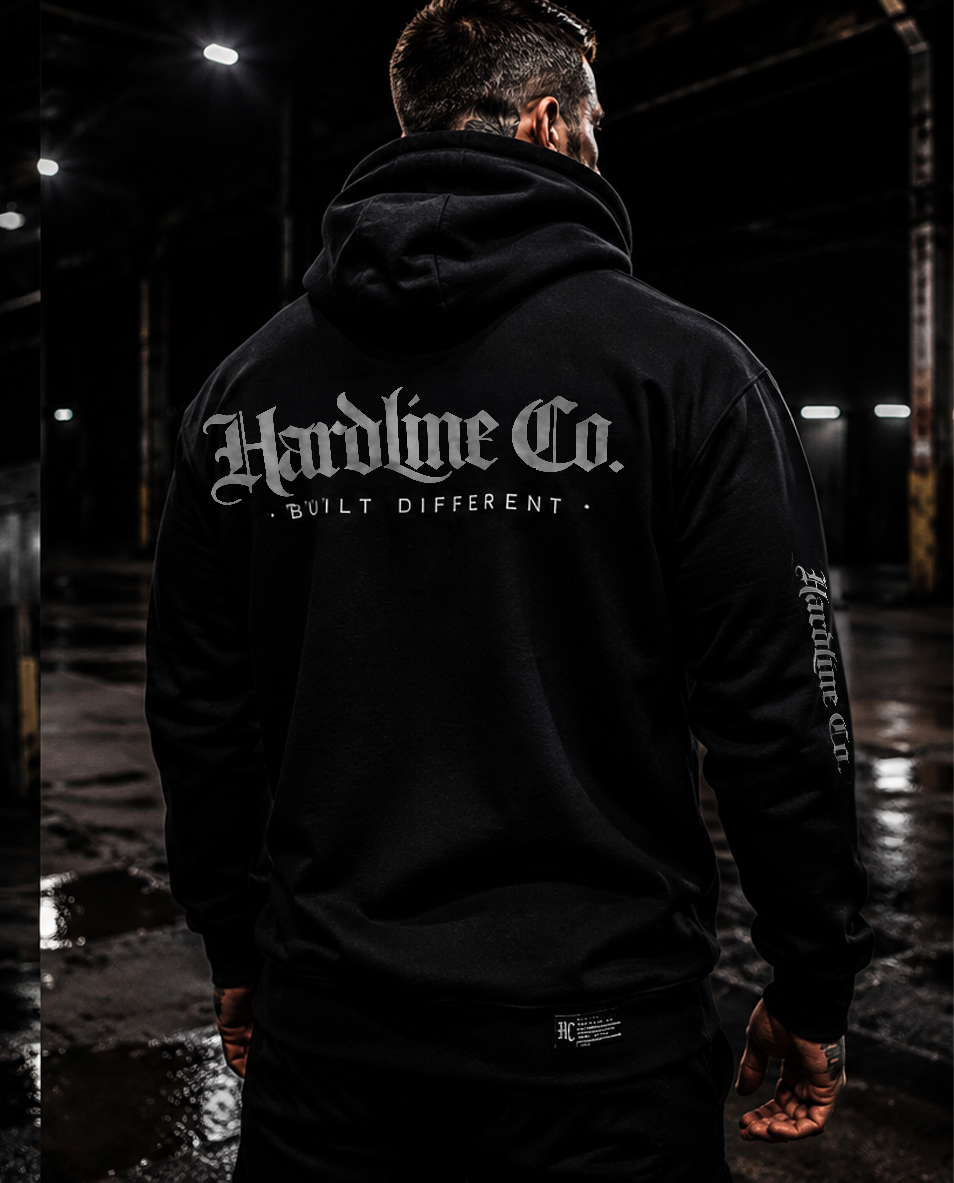 Man wearing a black Hardline Co. Hoodie showing the rear logo