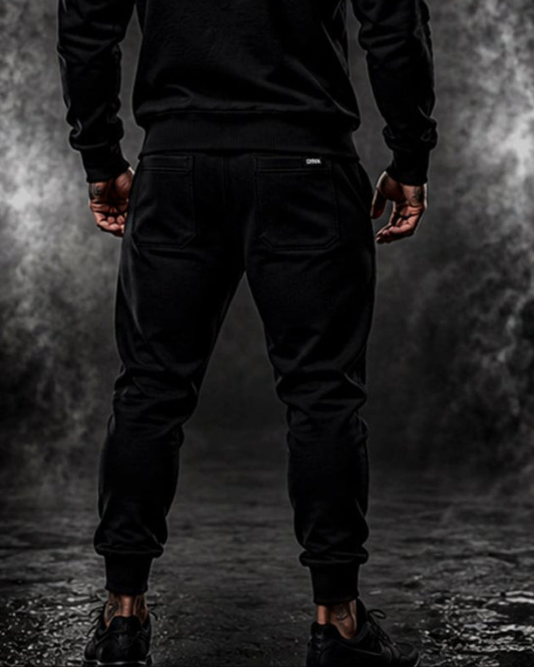 Rear view of a man wearing black DBXA Corestrike Pants