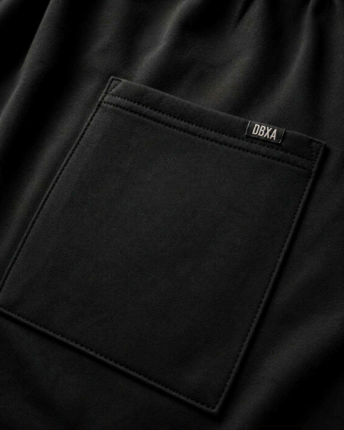 Close-up of a black pocket with a brand label on a dark background
