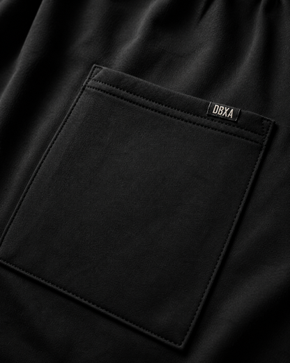 Close-up of a black pocket with a brand label on a dark background