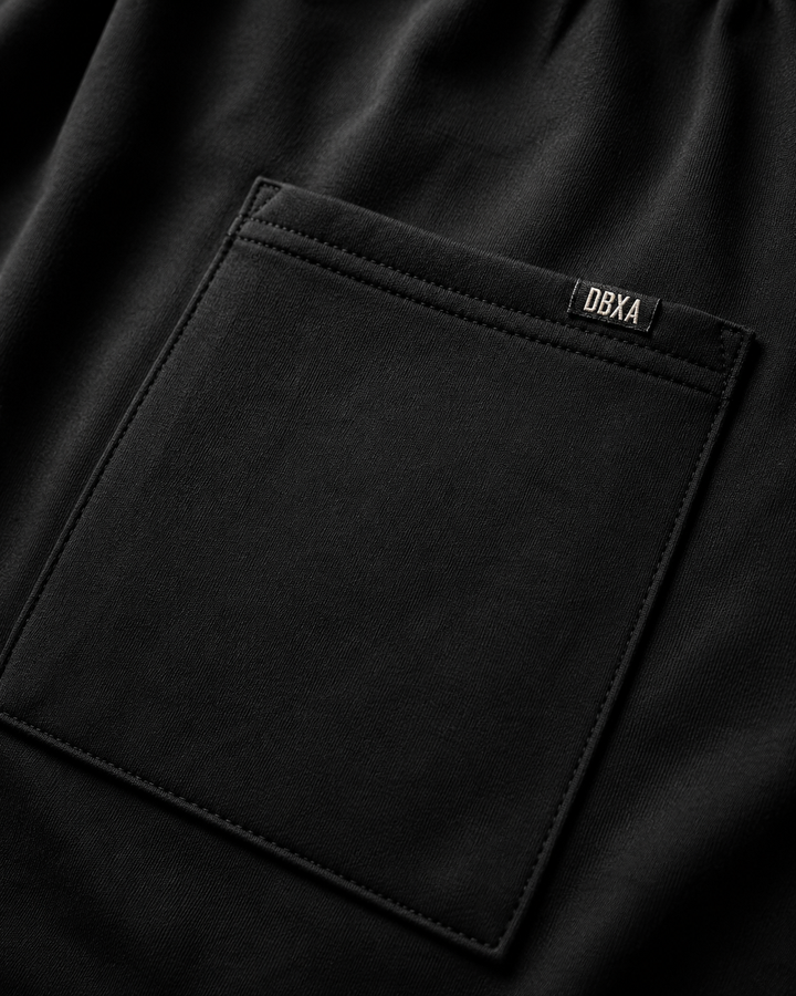 Close-up of a black pocket with a brand label on a dark background