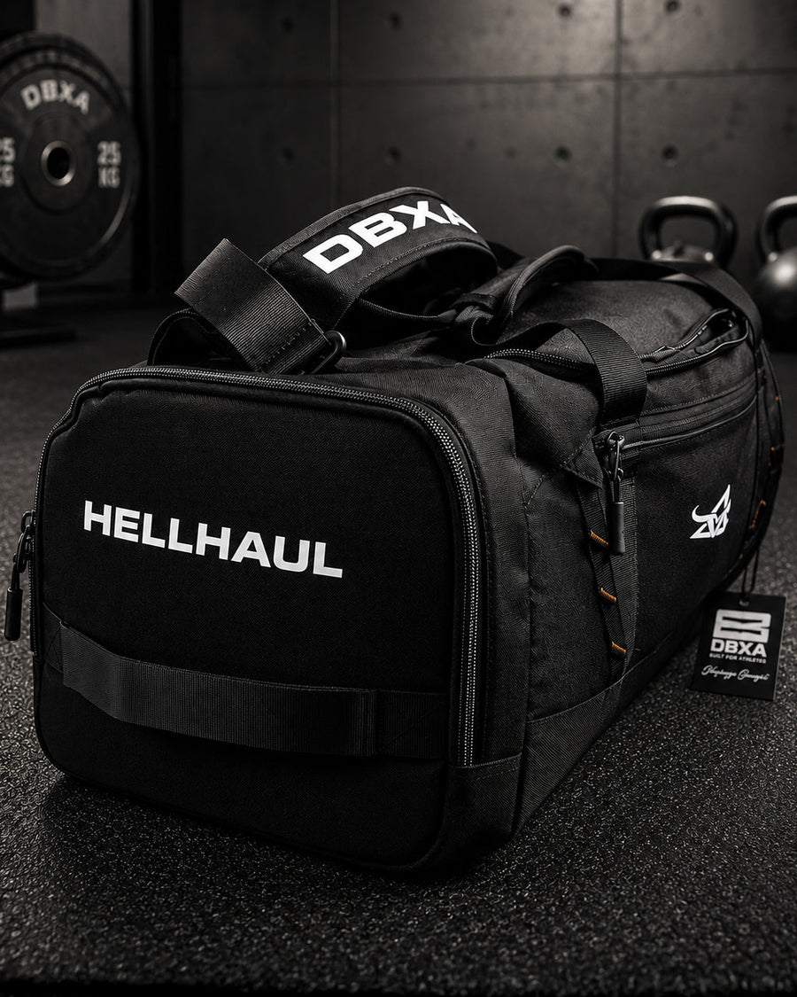 Black duffel bag with 'HELLHAUL' branding on a gym floor.