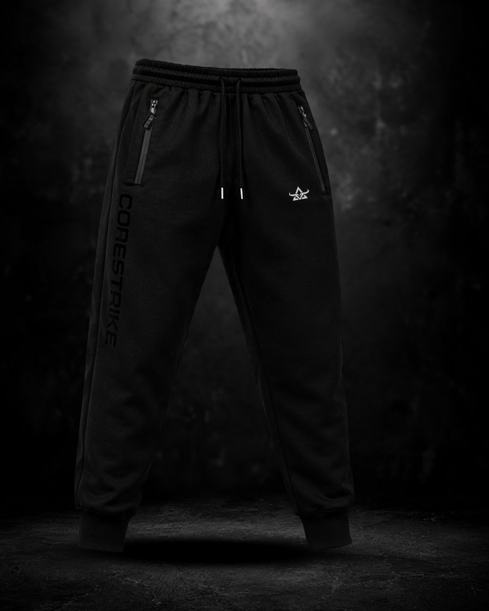 Black jogger pants with branding on a dark background
