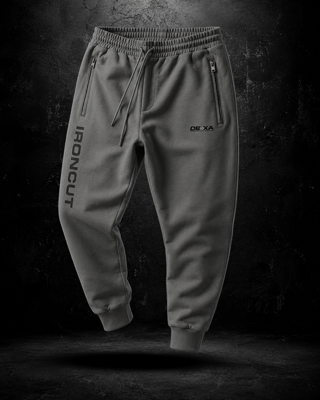 Gray jogger pants with branding on a dark background