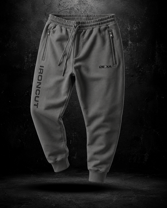 Gray jogger pants with branding on a dark background