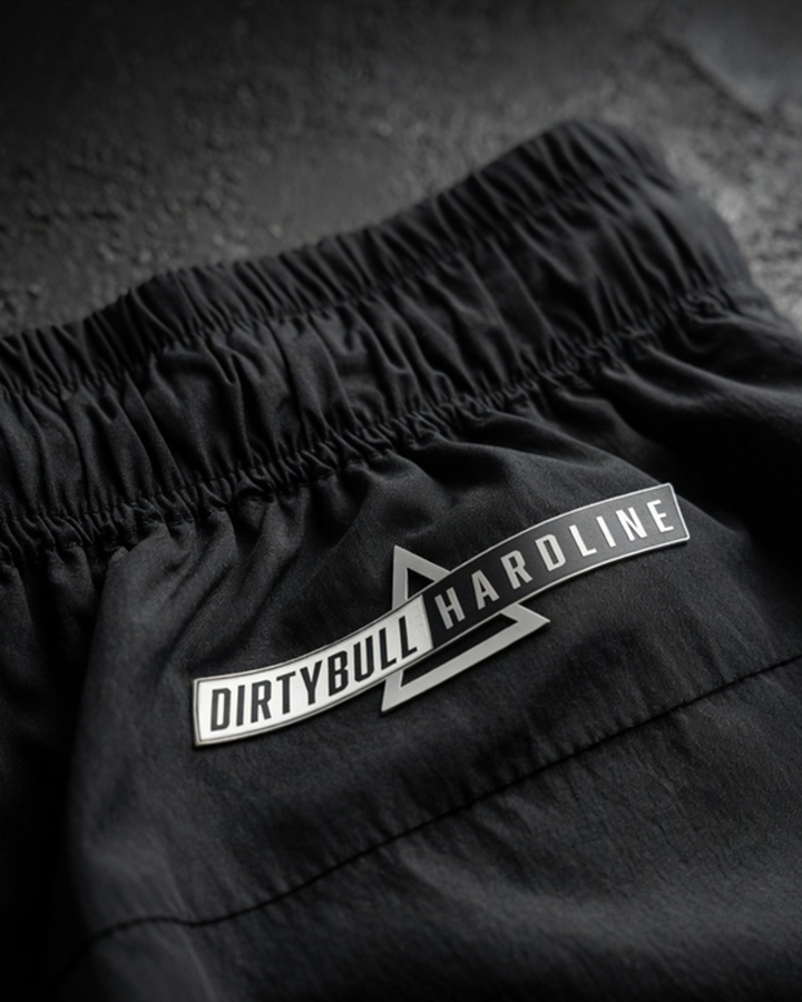 Black DBXA Ironstrike Shorts detail showing DirtyBull Hardline branding.