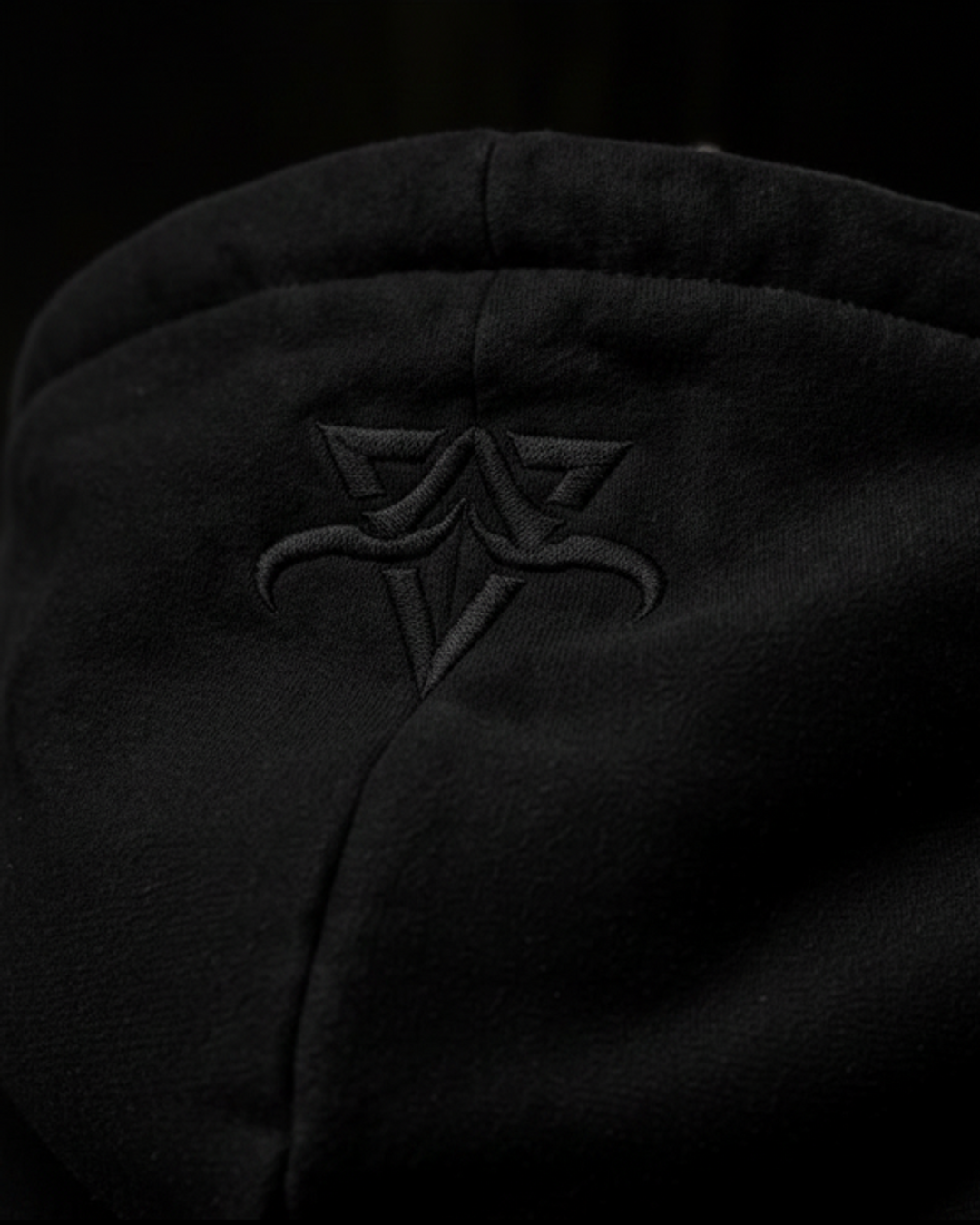 Close-up of the black DBXA Ironveil hood with embroidered DBXA branding.
