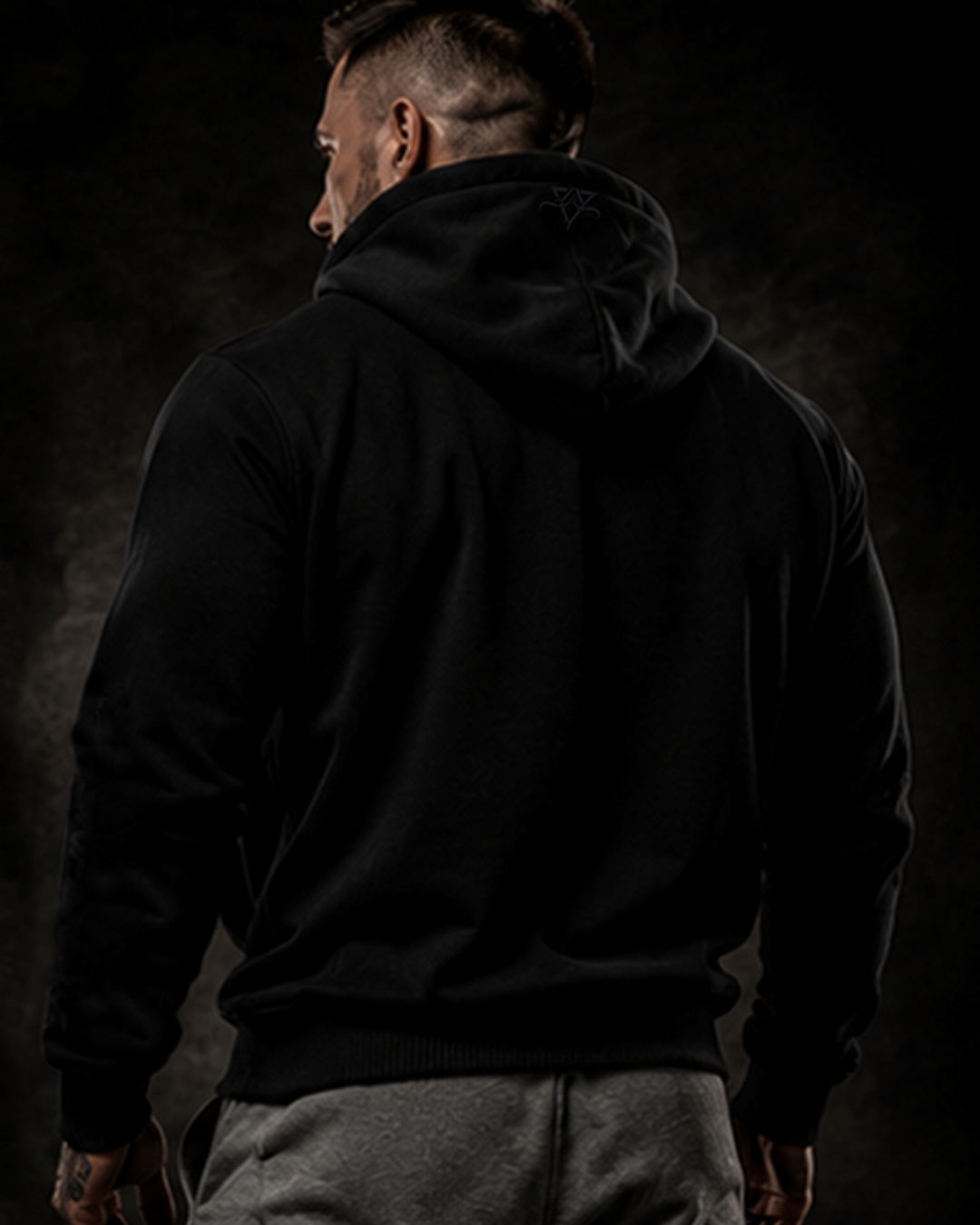 Rear view of the black DBXA Ironveil hoodie showing its plain back and embroidered hood detail.