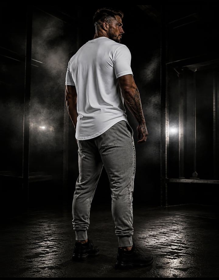 Rear view of a man wearing grey DBXA Ironcut Fleece Pants