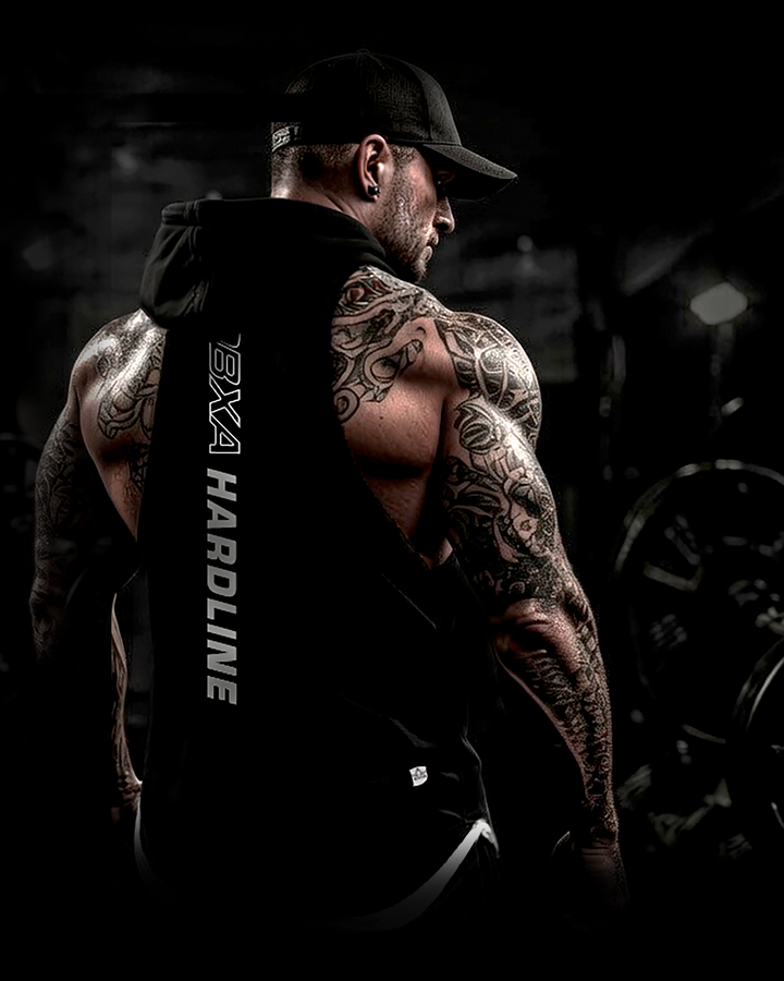 Muscular man wearing a black DBXA Ironcore Hooded Tank showing the vertical back print