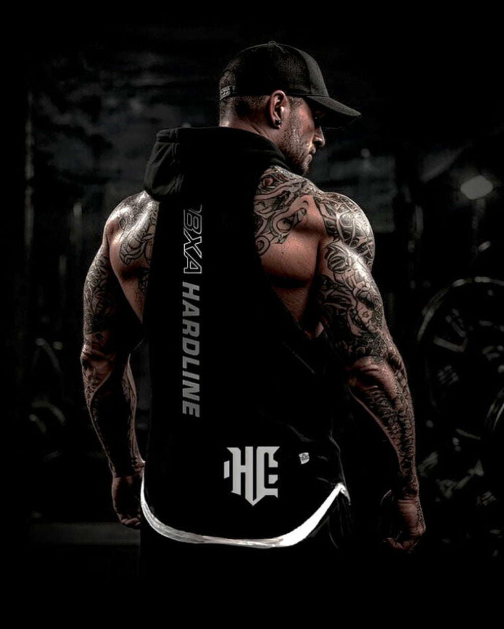Man wearing a black hoodie with 'Hardline' branding in a dark setting