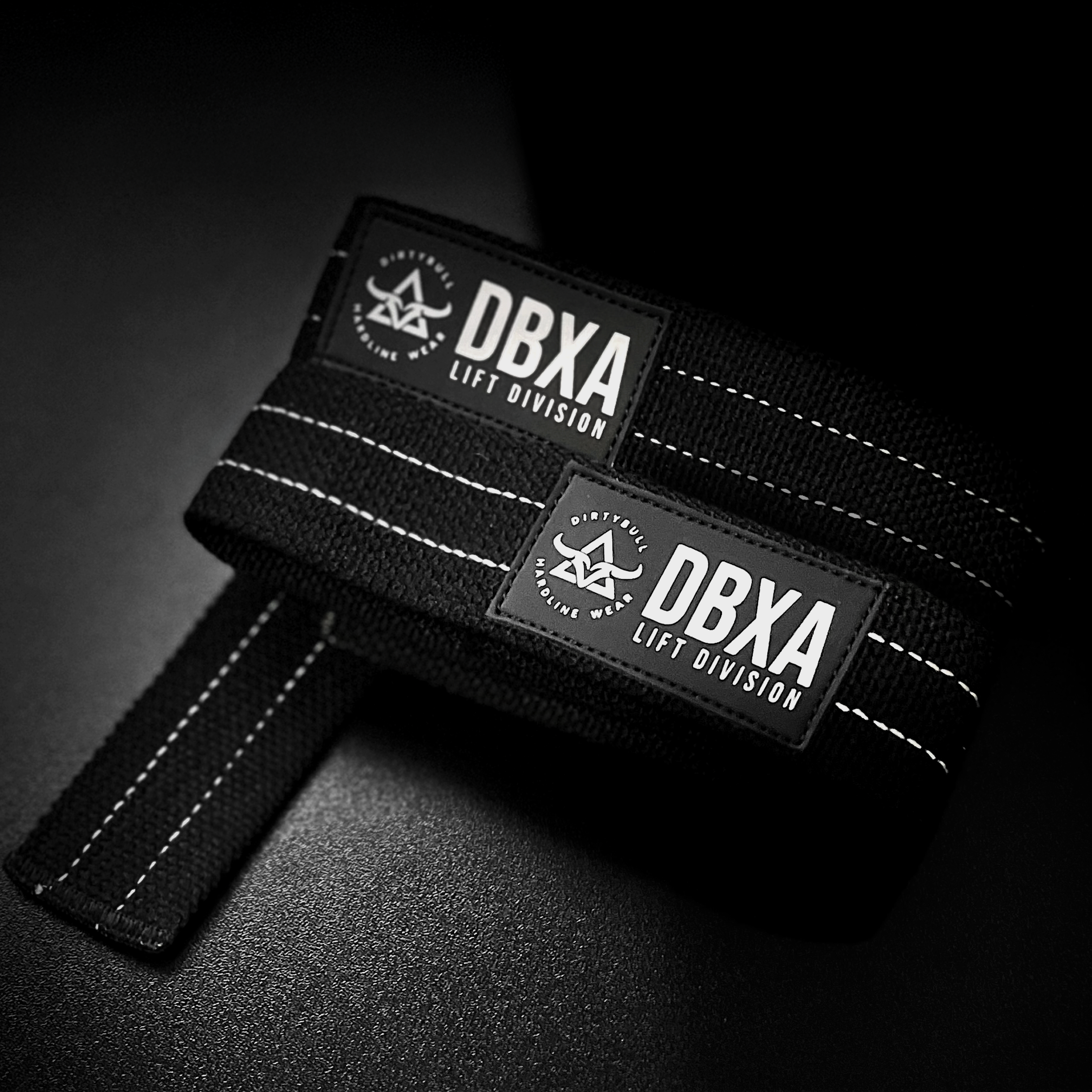 Black wrist wrap with DBXA Lift Division branding on a dark background