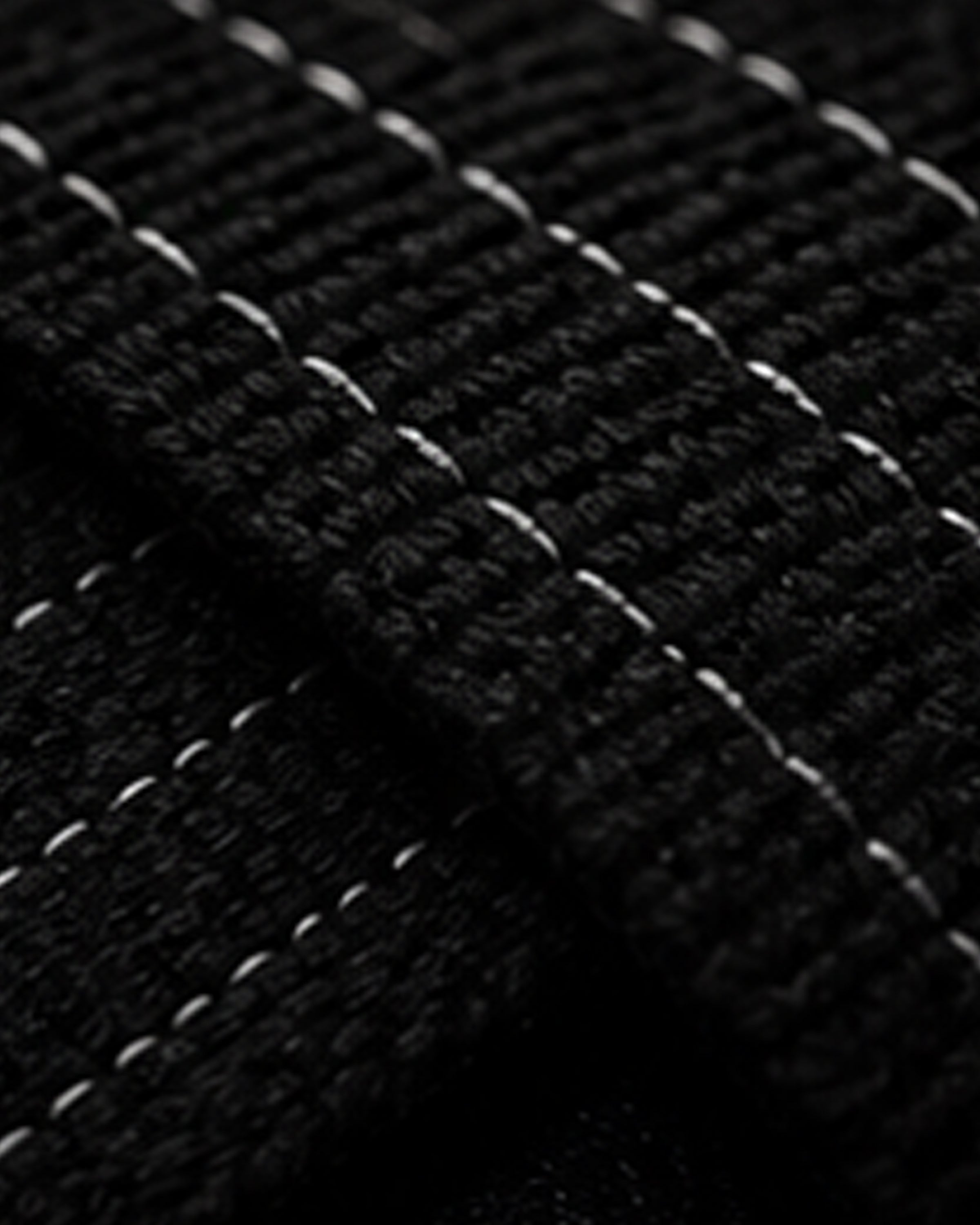 Close-up of a textured black surface with a grid pattern