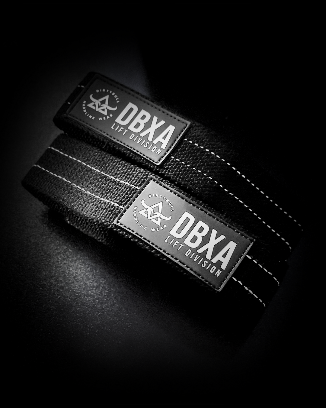 Black wrist wrap with DBXA Lift Division logo on a dark background