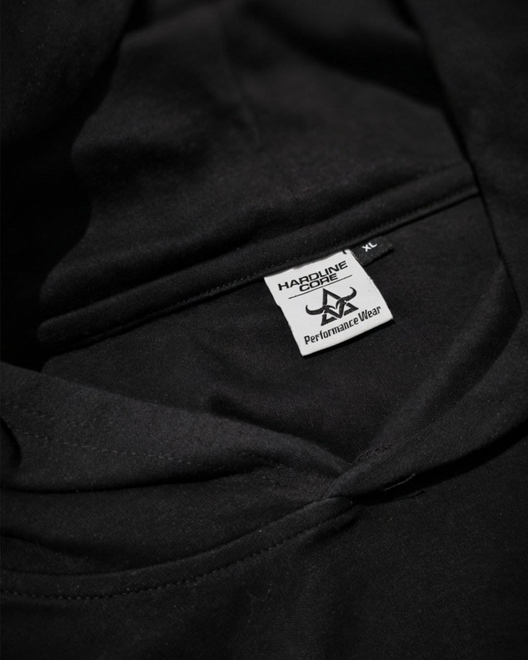 Close-up of the internal Hardline Core size label on the DBXA Ironcore Hooded Tank