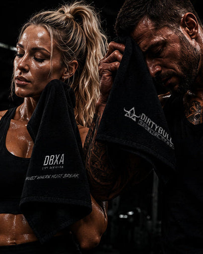 Two people with tattoos holding towels, one with 'DBX' branding, on a dark background.