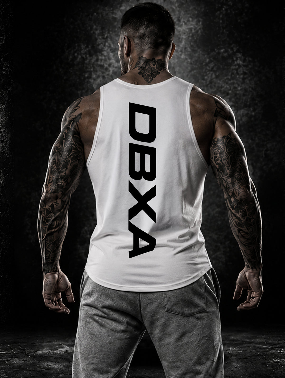 Muscular man wearing a white DBXA Hardline Tank showing the vertical rear logo